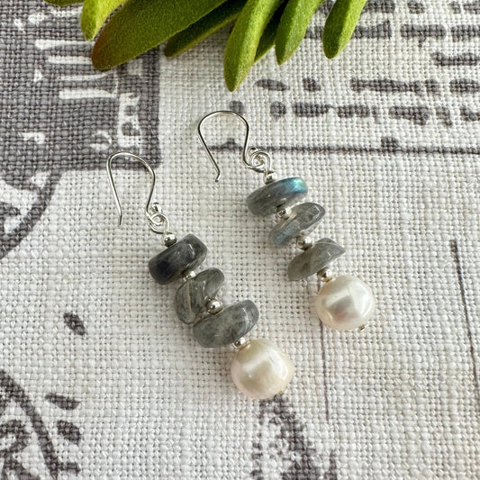 Add a touch of elegance and glamour to any outfit with these exquisitely crafted Pearl Lighting Earrings with a lustrous, genuine freshwater pearl paired with a smooth, alluring labradorite gemstone disks, and hung on a sterling silver French ear hook