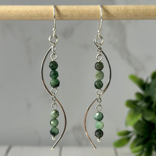 These Sweet Peas Earrings, featuring African Emerald faceted beads gemstones dropped in 925 Sterling Silver chain and set in ear hooks and hammered wire, are perfect for adding a sophisticated sparkle to your ears.