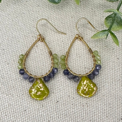  Elevate your style with these beautiful earrings. Peridot and Iolite beads. 