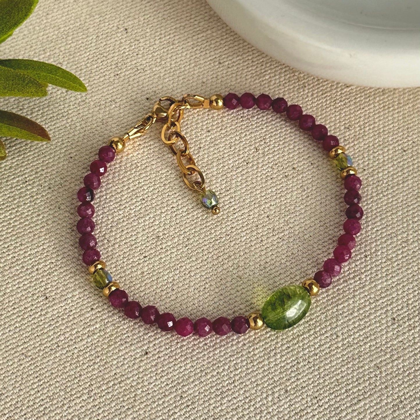 Cool bracelet made with Ruby faceted, green quartz and gold accessories.