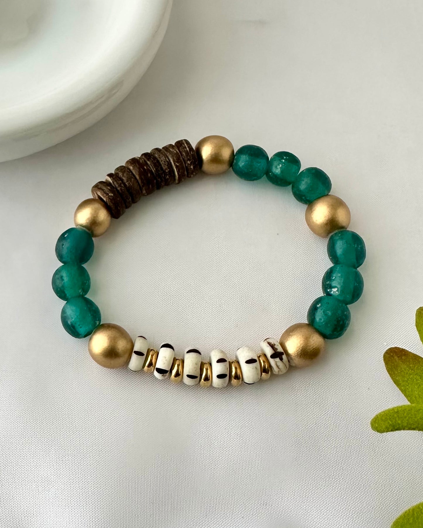 Cobalt Green Bracelet is handmade and eco-friendly. Crafted from African recycled lass beads, natural carved beads, and gold wood beads