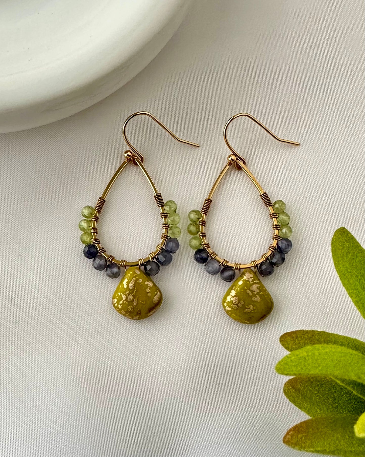  Elevate your style with these beautiful earrings. Peridot and Iolite beads. 